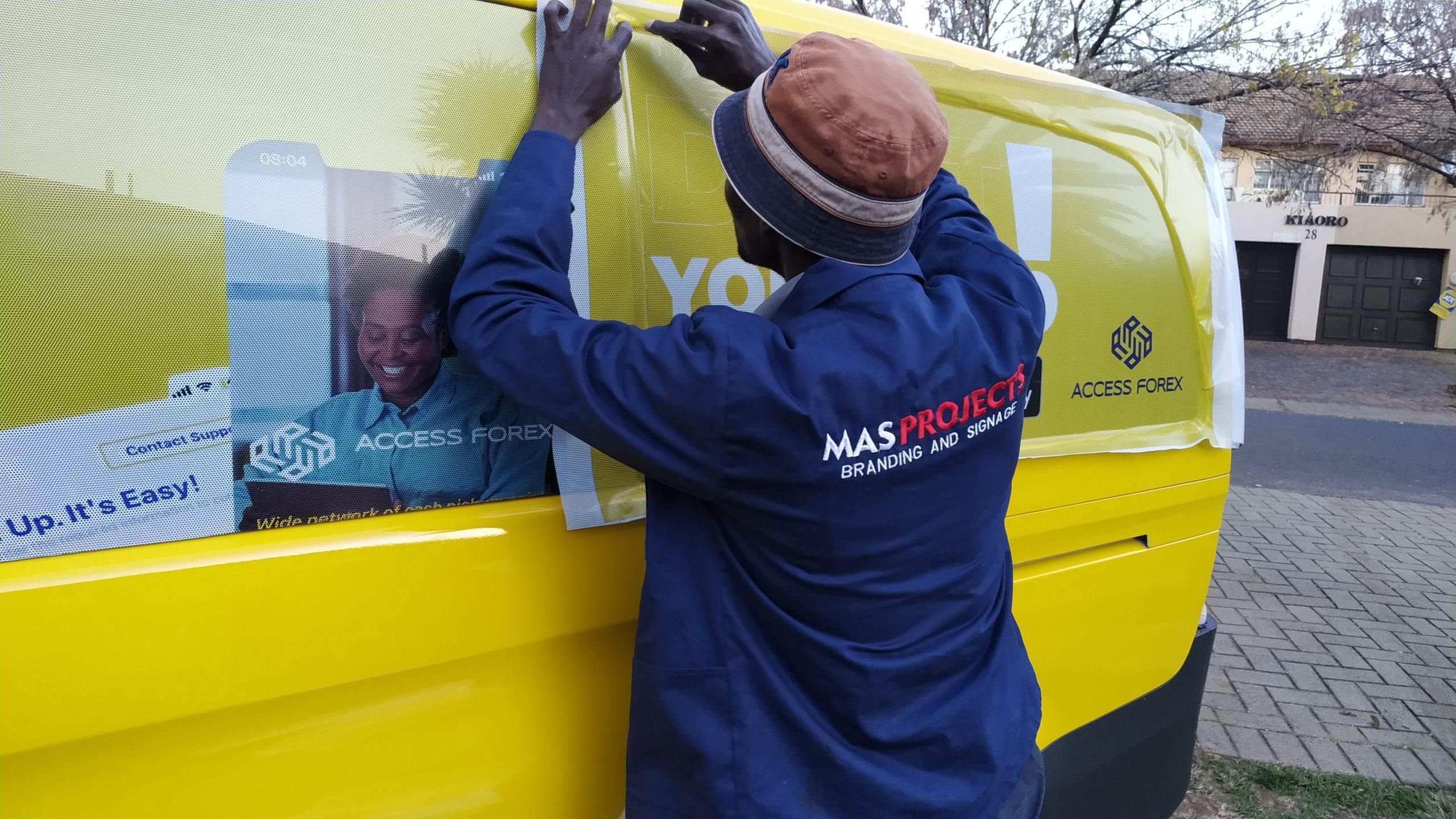 Vehicle wrapping installation by Masproclean Branding and Signage, featuring skilled professionals applying high-quality wraps to transform vehicles into eye-catching mobile advertisements